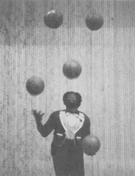 [Smith juggles 5 basketballs, photo]
